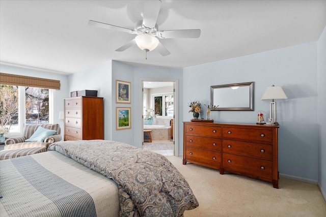 carpeted bedroom featuring ceiling fan and ensuite bath