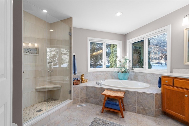 bathroom featuring shower with separate bathtub and vanity