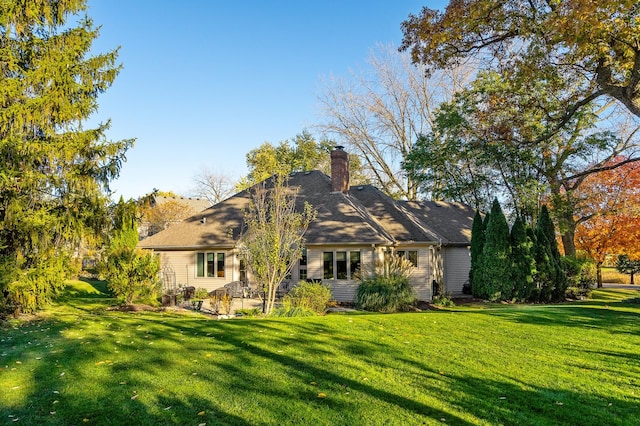 rear view of house with a yard