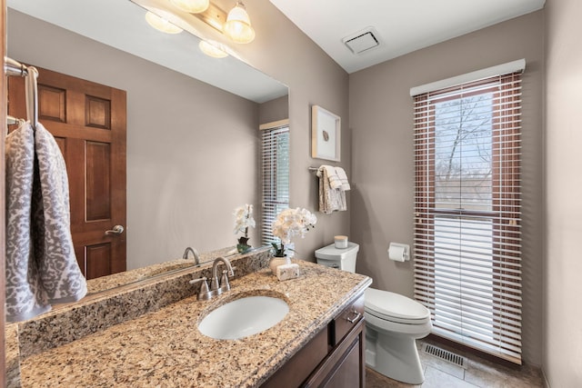 bathroom with tile patterned floors, vanity, and toilet