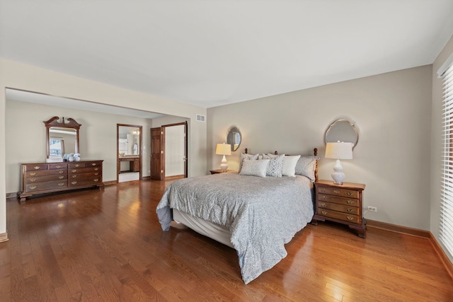 bedroom featuring hardwood / wood-style floors and multiple windows