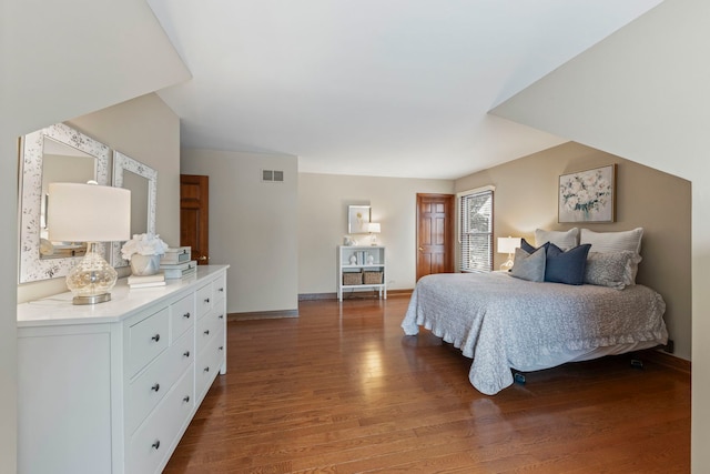 bedroom with dark wood-type flooring