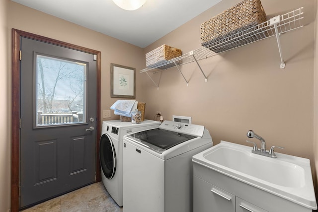 laundry area with independent washer and dryer and sink