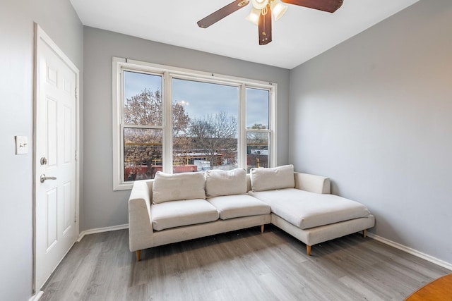 living room with ceiling fan and light wood-type flooring