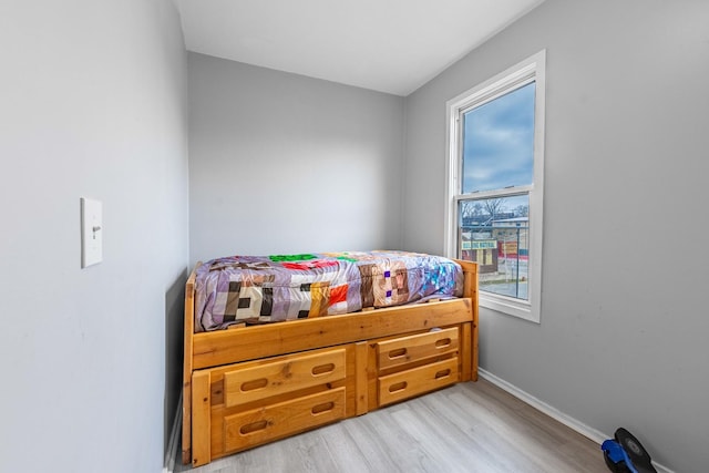 bedroom featuring light hardwood / wood-style flooring and multiple windows