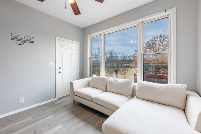 living room featuring hardwood / wood-style floors and ceiling fan