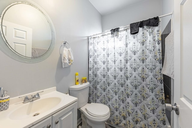 bathroom with walk in shower, vanity, and toilet