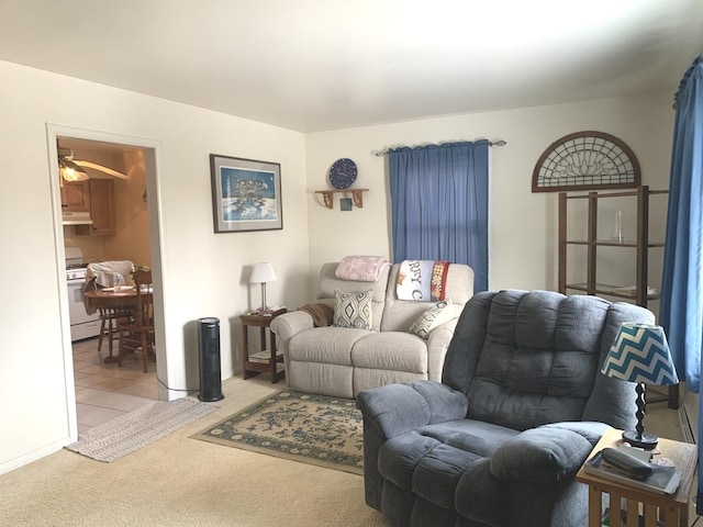 carpeted living room featuring ceiling fan