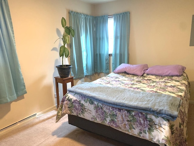 bedroom with light colored carpet and a baseboard radiator