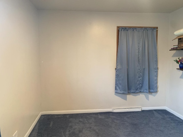 carpeted empty room featuring baseboard heating