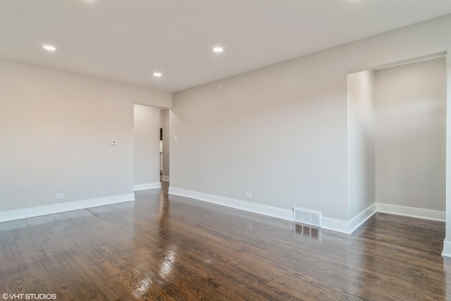 unfurnished room with dark hardwood / wood-style flooring