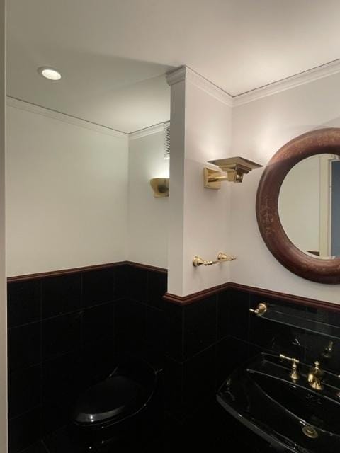 bathroom with ornamental molding and sink