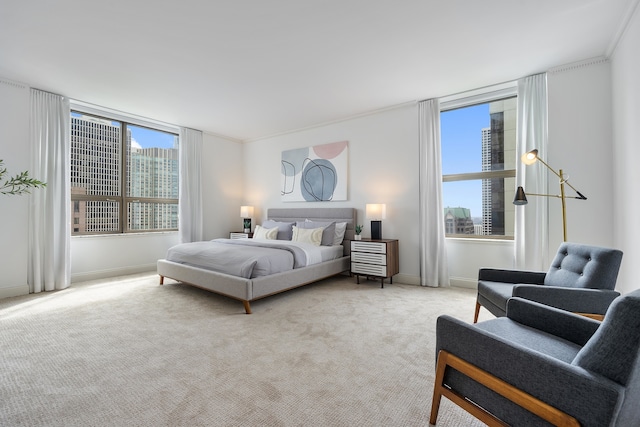 bedroom featuring ornamental molding, light carpet, and multiple windows