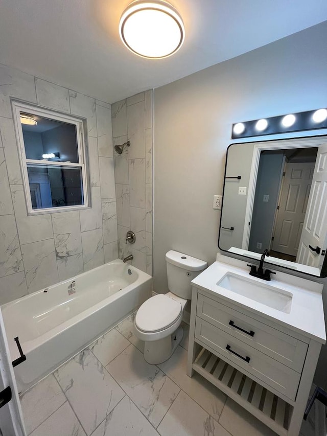 full bathroom featuring vanity, tiled shower / bath combo, and toilet