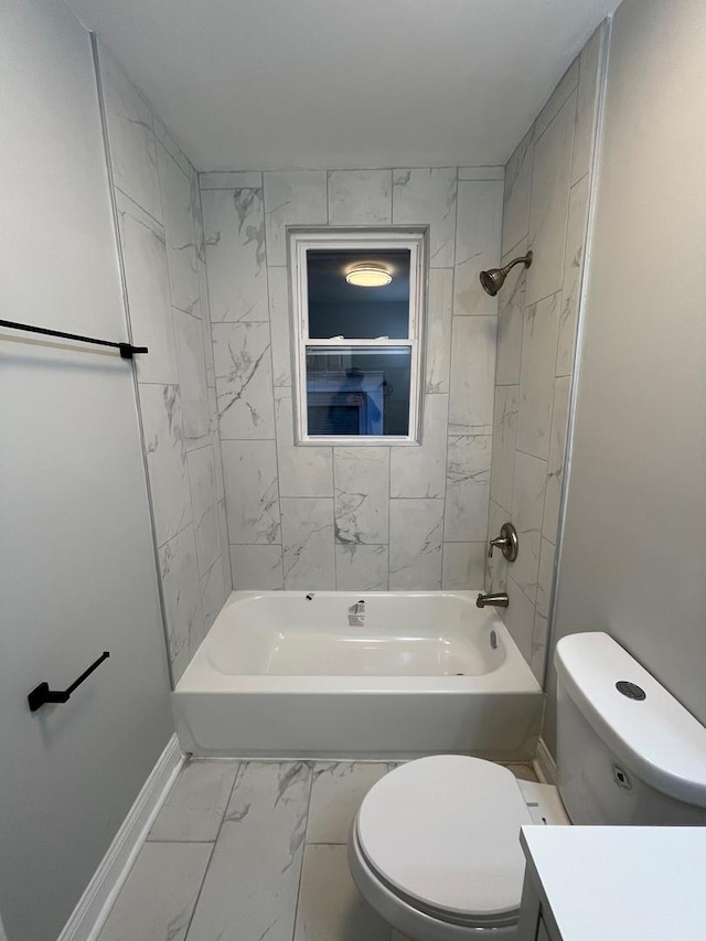 full bathroom featuring tiled shower / bath combo, toilet, and vanity