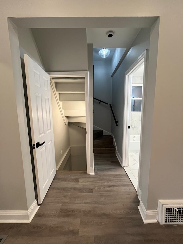 hall with dark wood-type flooring