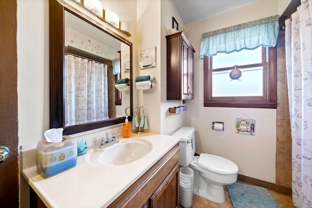 bathroom featuring tile patterned floors, vanity, and toilet