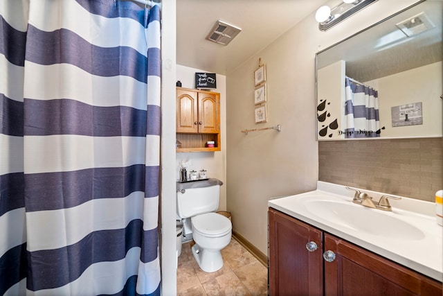 bathroom with toilet, backsplash, walk in shower, and vanity