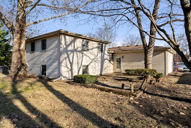 rear view of house with a lawn