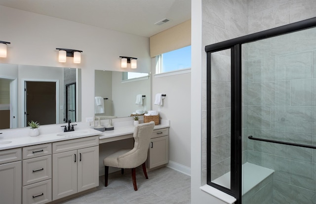 bathroom featuring vanity, tile patterned floors, and walk in shower