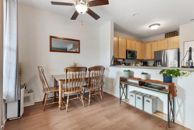 kitchen featuring ceiling fan, light wood-type flooring, light brown cabinetry, and appliances with stainless steel finishes