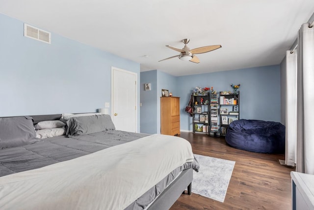 bedroom featuring ceiling fan and dark wood-type flooring