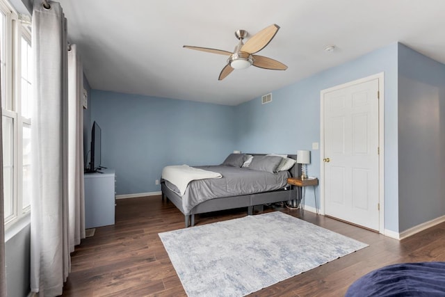 bedroom with ceiling fan and dark hardwood / wood-style flooring