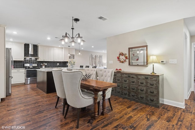 dining area featuring dark wood-type flooring and a notable chandelier