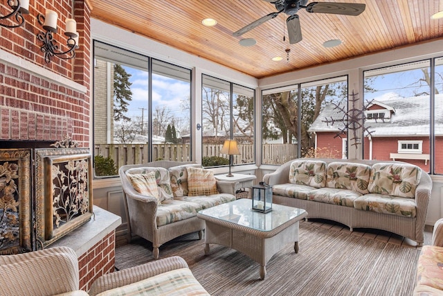 sunroom / solarium with wood ceiling and ceiling fan