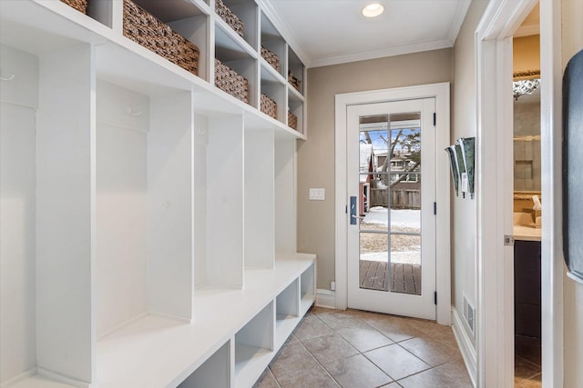 mudroom with light tile patterned floors and ornamental molding