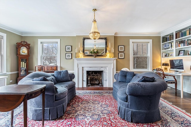 living room with a fireplace, hardwood / wood-style floors, and crown molding