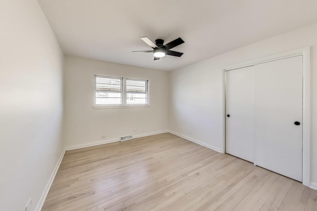 unfurnished bedroom with a closet, ceiling fan, and light hardwood / wood-style flooring