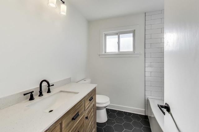 bathroom featuring vanity, tile patterned flooring, and toilet