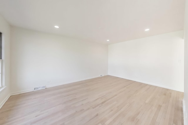 empty room with light hardwood / wood-style flooring