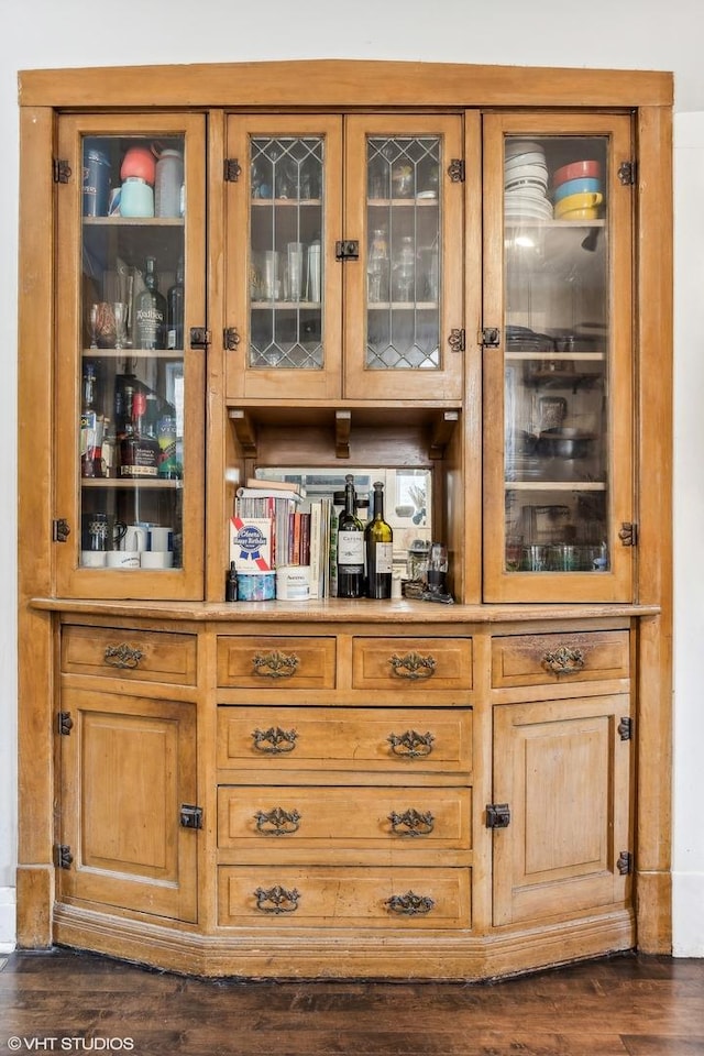 bar with dark hardwood / wood-style flooring