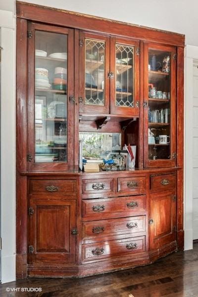 bar with dark hardwood / wood-style flooring