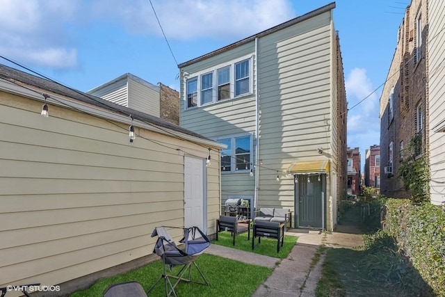 rear view of house with a lawn