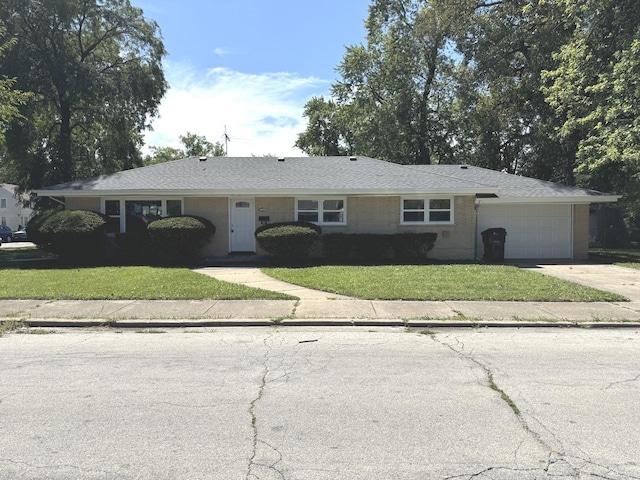 ranch-style house with a front yard and a garage