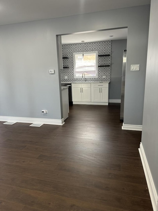 hallway featuring dark wood-type flooring and sink