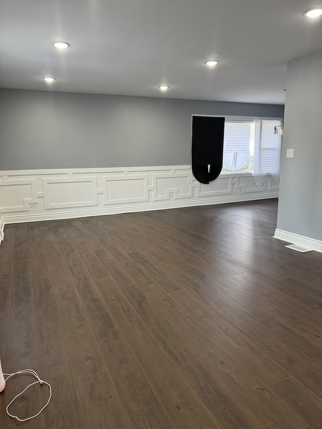 spare room featuring dark wood-type flooring