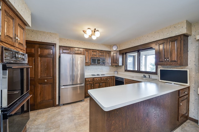 kitchen featuring sink, black appliances, and kitchen peninsula