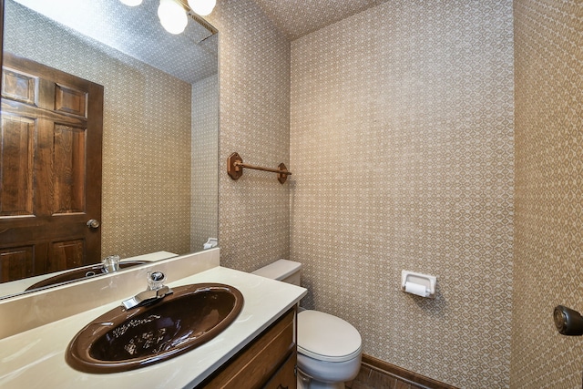 bathroom featuring vanity and toilet