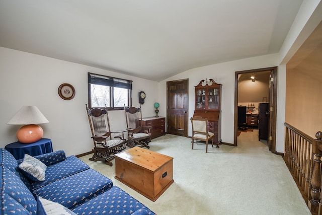 carpeted living room featuring vaulted ceiling