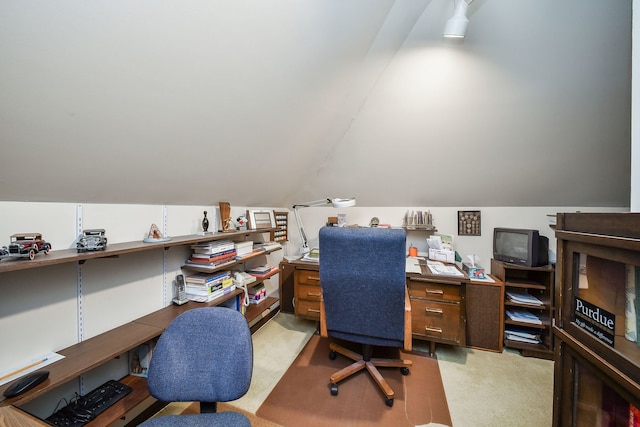 carpeted home office with lofted ceiling