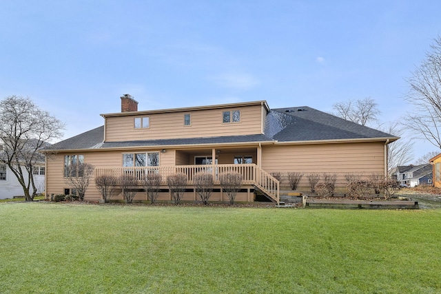 rear view of property featuring a wooden deck and a yard