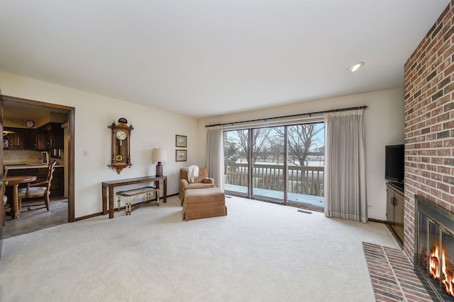 living area with carpet and a brick fireplace