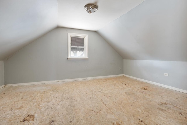 additional living space featuring lofted ceiling