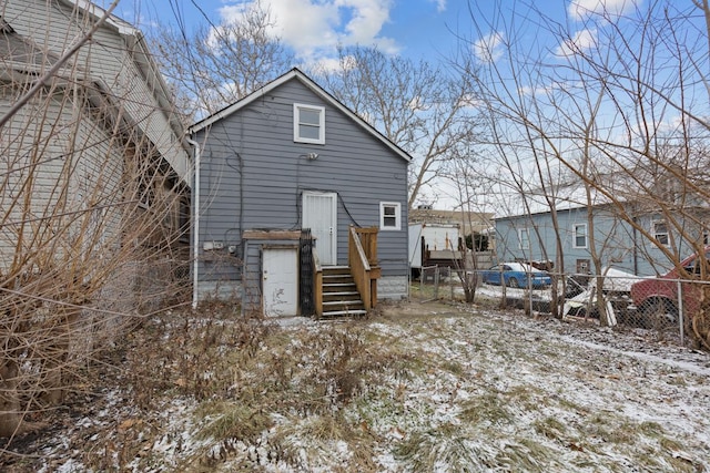 view of snow covered back of property