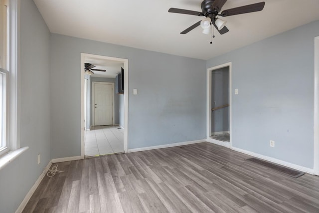 spare room with hardwood / wood-style flooring and ceiling fan