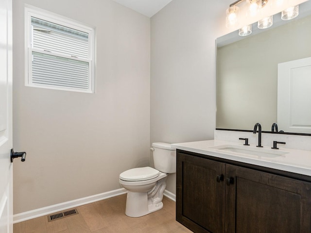 bathroom with toilet and vanity